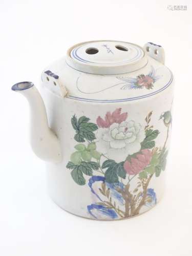 A large Oriental teapot decorated with flowers, fo…
