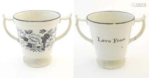 A pedestal loving cup with shaped handles, the bod…