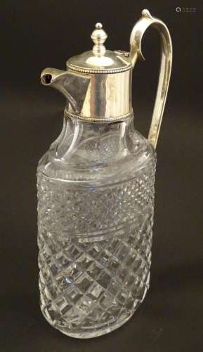 A glass claret jug of ovoid form with silver plate…