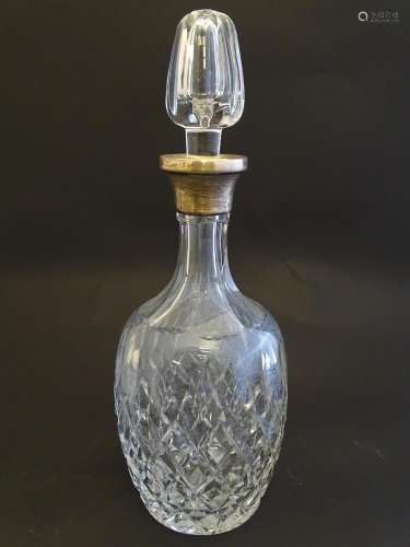 A cut glass decanter with silver collar hallmarked…
