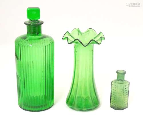 Assorted green glass comprising 2 bottles and a va…