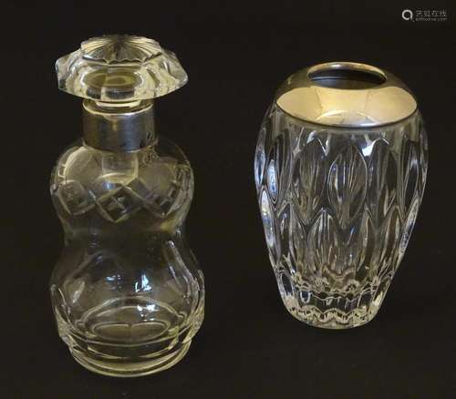 A cut glass scent / perfume bottle with silver col…