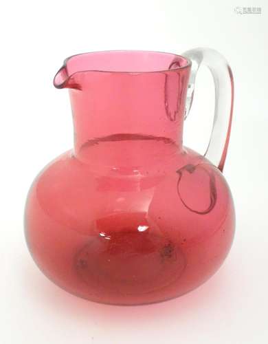 A late 19thC / early 20thC cranberry glass jug wit…