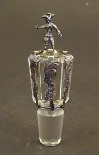 A glass decanter stopper with silver mounts bearin…