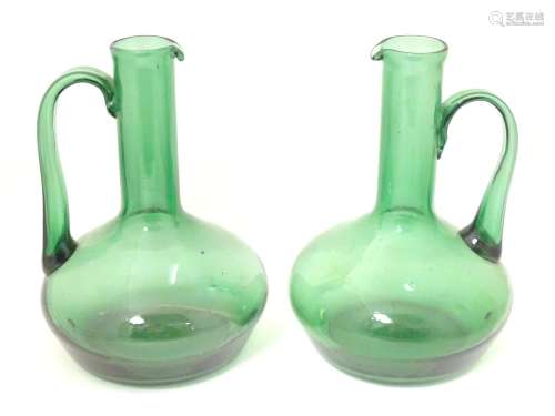 Two green glass jugs with provision for conversion…