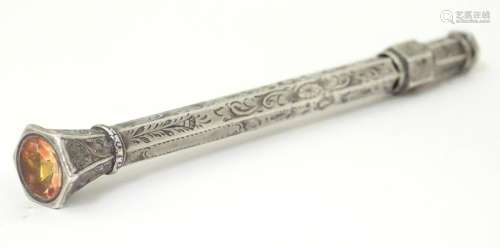 A white metal pencil with engraved decoration and …