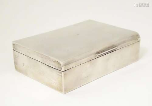 A silver cigarette box with wood lined interior. H…