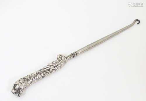 A Victorian button hook with white metal handle wi…