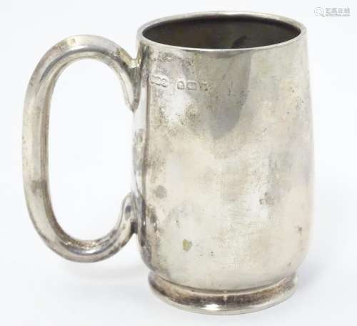 A silver christening mug with loop handle. Hallmar…