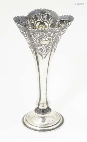 A Victorian silver bud vase with embossed C scroll…