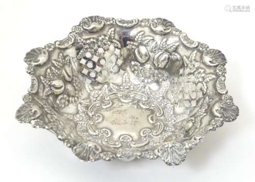 A silver pin dish with pierced and embossed decora…