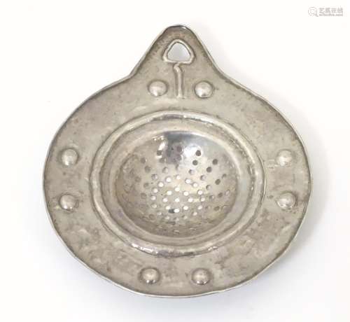 An Arts & Crafts white metal lemon strainer with h…
