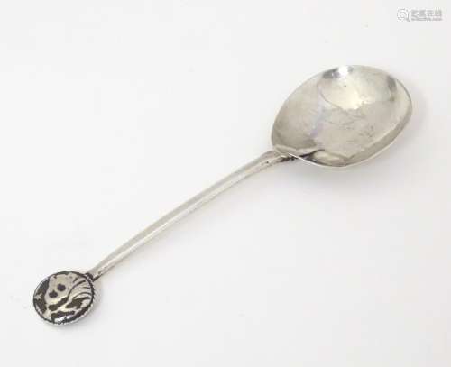 An Arts and Crafts silver spoon with lion head det…