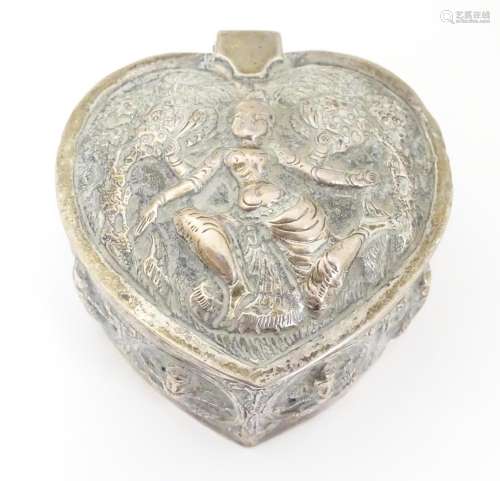 A white metal box of heart form with hinged lid an…