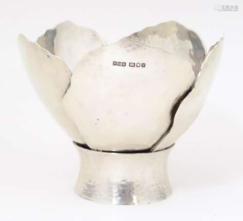 A Queen Elizabeth II silver bowl of stylised flowe…