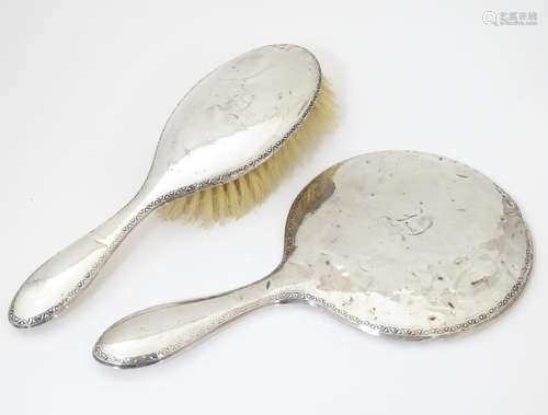 A silver backed hand mirror and hair brush hallmar…