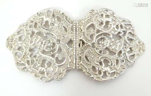 A two sectional silver buckle with cherub decorati…