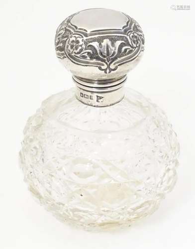 A cut glass perfume / scent bottle with silver lid…