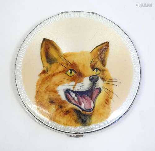 A silver powder compact with enamel fox head decor…