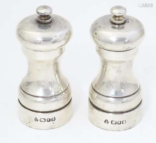 A pair of silver pepper grinders / pepper mills, h…