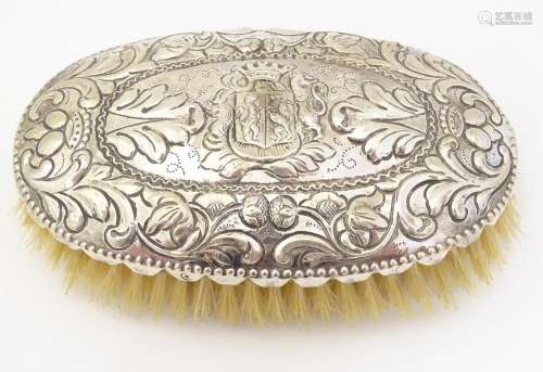 A Continental brush of oval form with silver mount…