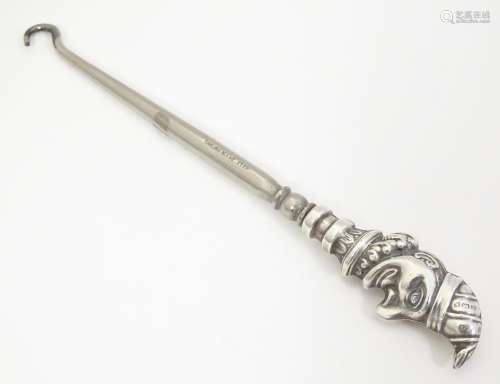 A button hook with a novelty silver handle formed …