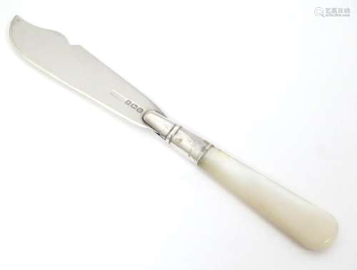 A silver butter knife hallmarked with mother of pe…