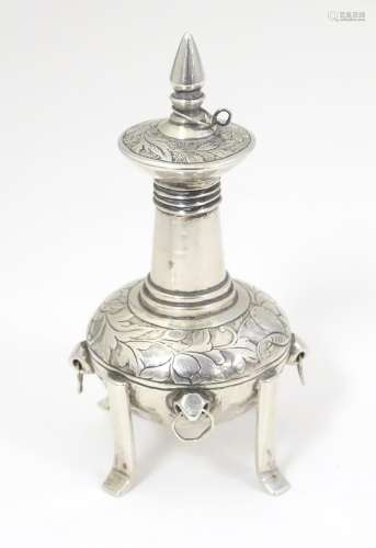 A white metal scent bottle with engraved decoratio…
