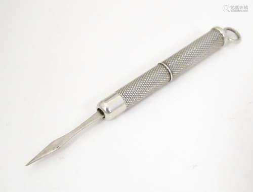 A retractable silver tooth pick with engine turned…