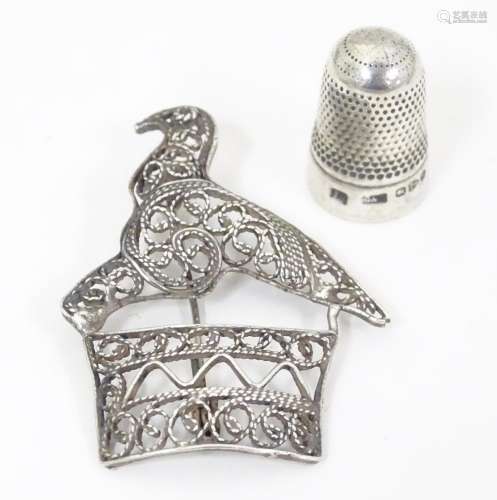A silver thimble hallmarked Chester 1895. Together…