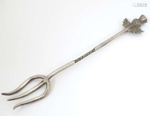 A white metal sweetmeat fork with thistle decorati…