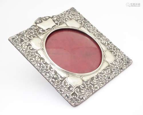 An Art Nouveau photograph frame with embossed silv…