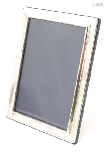 A photograph frame with silver surround hallmarked…