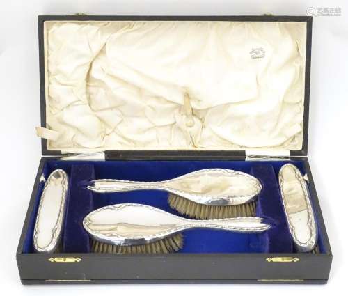 Four cased silver backed brushes hallmarked Birmin…