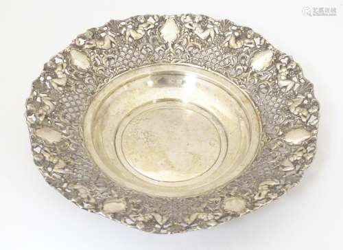 A silver plate dish with embossed cherub detail. 1…