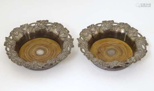 A pair of silver plate bottle coasters with fruiti…