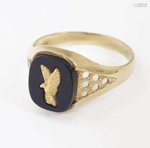 A 9ct gold and onyx signet ring. Ring approx size …