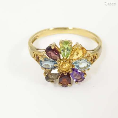 A 9ct gold ring set with various coloured stones i…