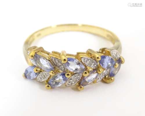 A 9ct gold ring set with diamonds and tanzanites. …