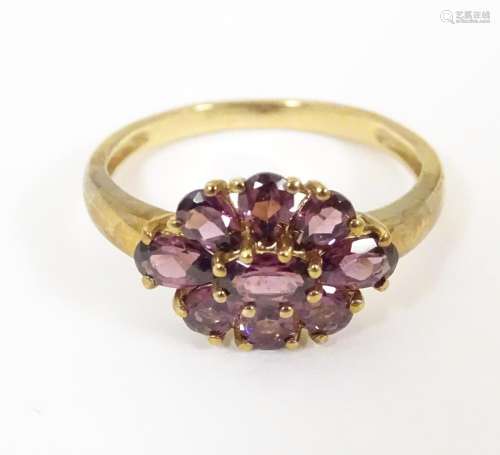 A 9ct gold ring set with amethysts. Ring size appr…