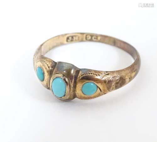 A 9ct gold ring set with graduated turquoise caboc…
