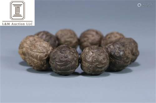 A Chinese Carved Agarwood Lion Patterned Bracelet