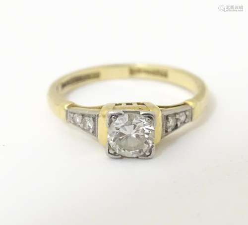 An 18ct gold ring with platinum set central solit…