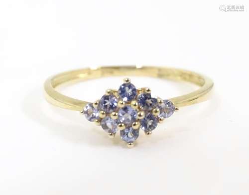 A 9ct gold ring set with tanzanite coloured stones…