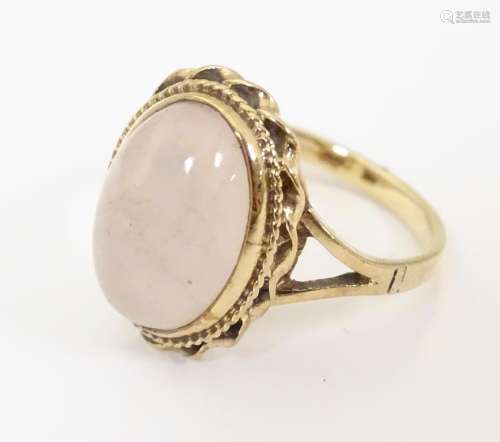 A 9ct gold ring set with rose quartz oval cabochon…