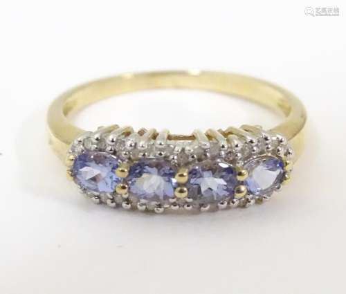 A 9ct gold ring set with 4 tanzanite coloured ston…
