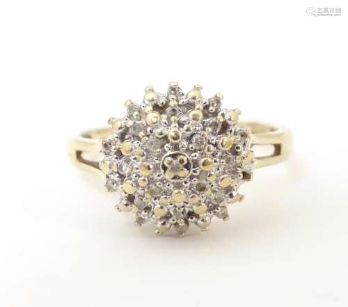 A 9ct gold ring set with cluster of diamonds to to…