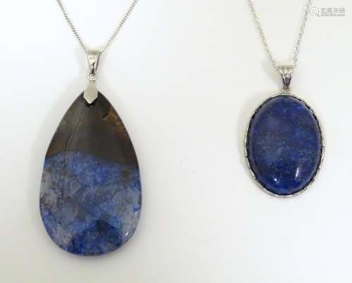 Two necklaces both set with hardstone pendants on…