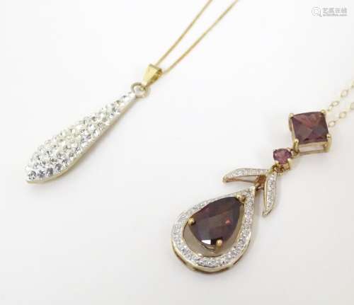 A 9ct gold necklace, the pendant set with garnet a…