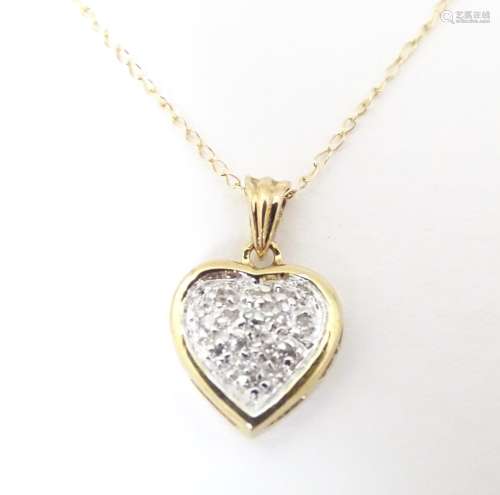 A 9ct gold necklace, the heart shaped pendant set…